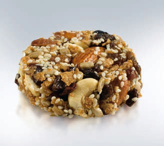 A round cereal and nut snack made with cashews, almonds, raisins, and puffed gains.