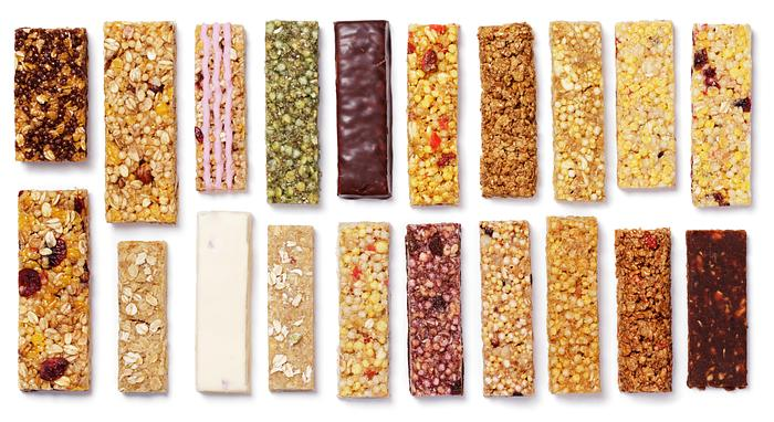 An assortment of cereal and granola bars in various flavours and coatings.
