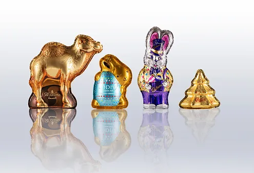 An assortment of novelty hollow chocolate figures wrapped in aluminium foil packaging.
