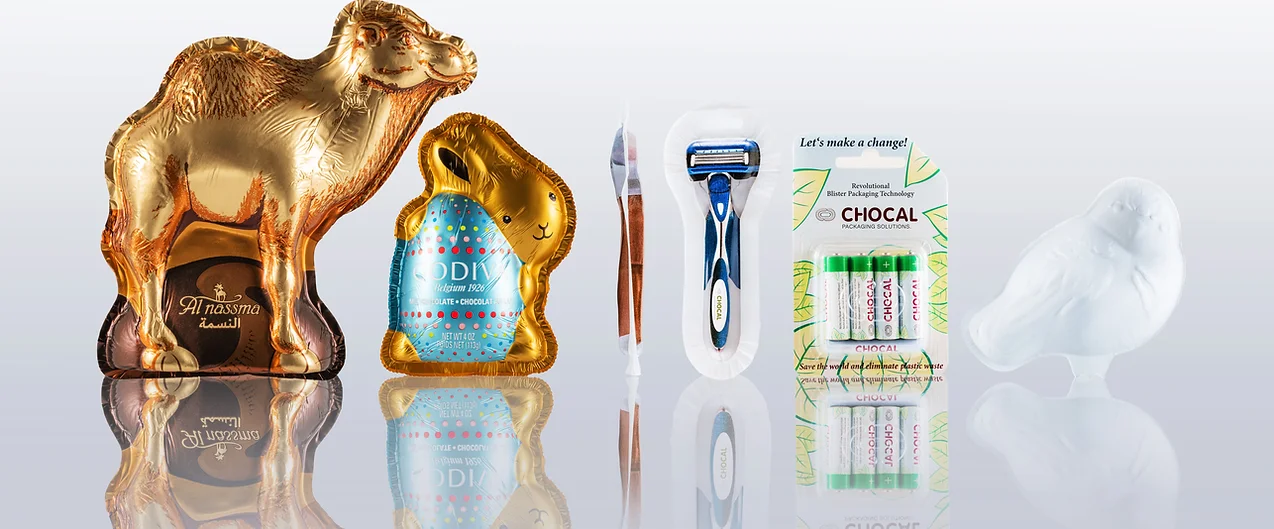 Assortment of foil wrapped and paper packaged items by Chocal including chocolate and non-food items