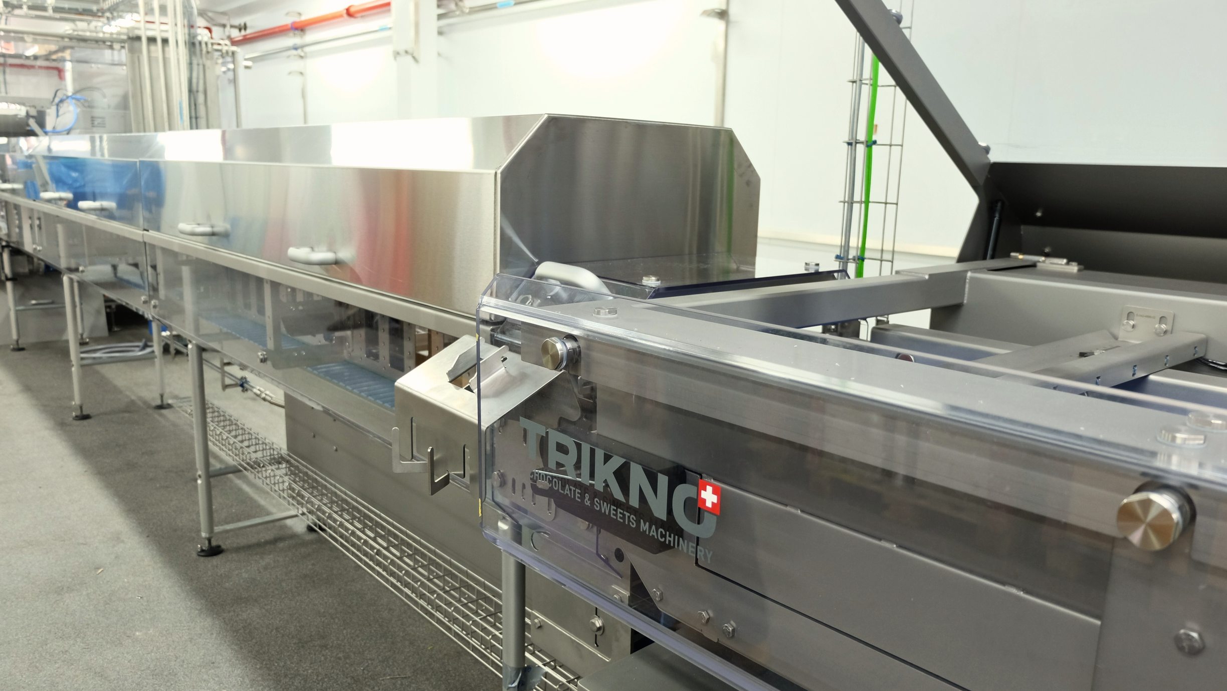 Trikno branded industrial cooling tunnel in a food production facility.