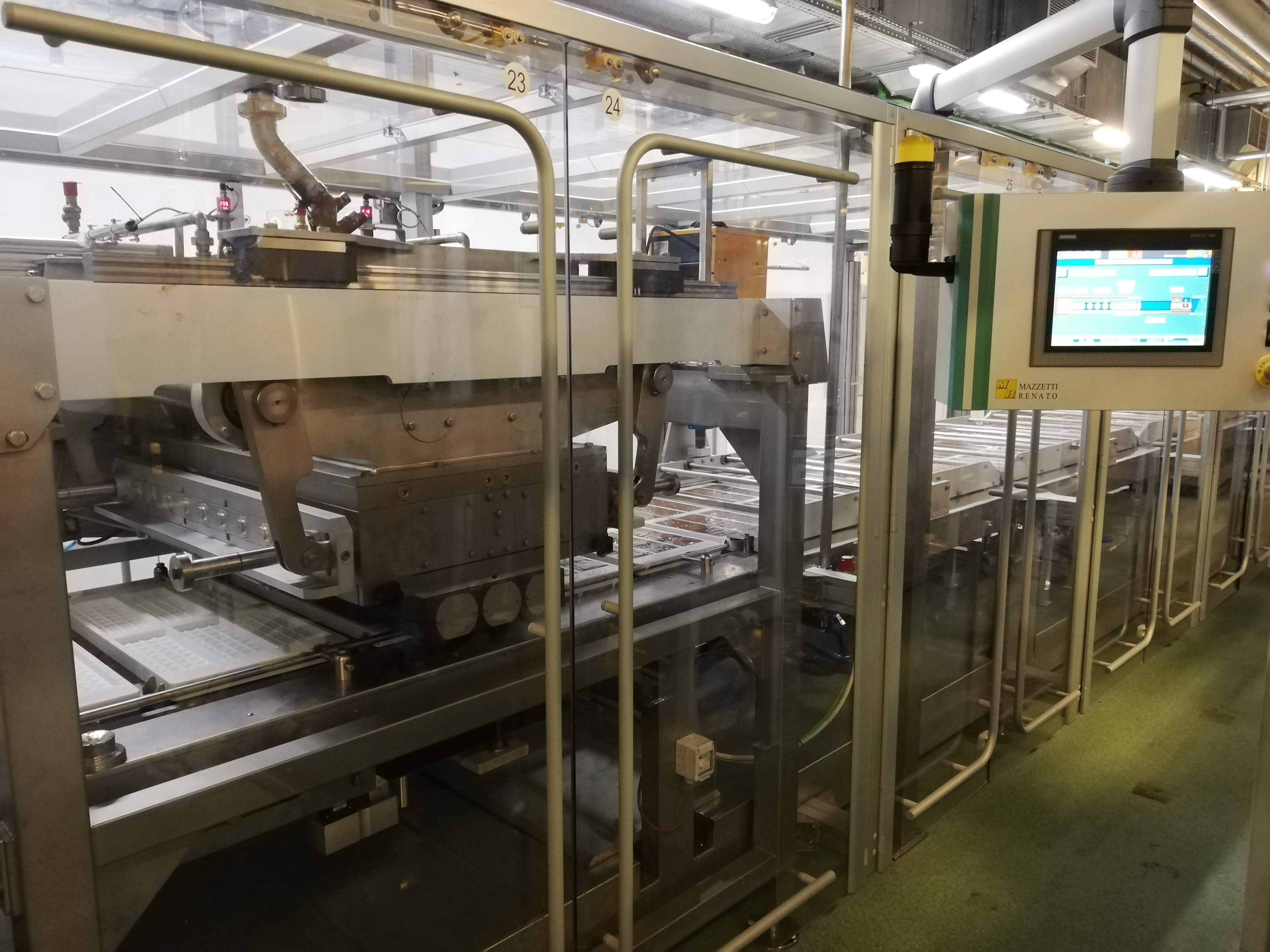Industrial food processing machine with a digital control panel inside a production facility.