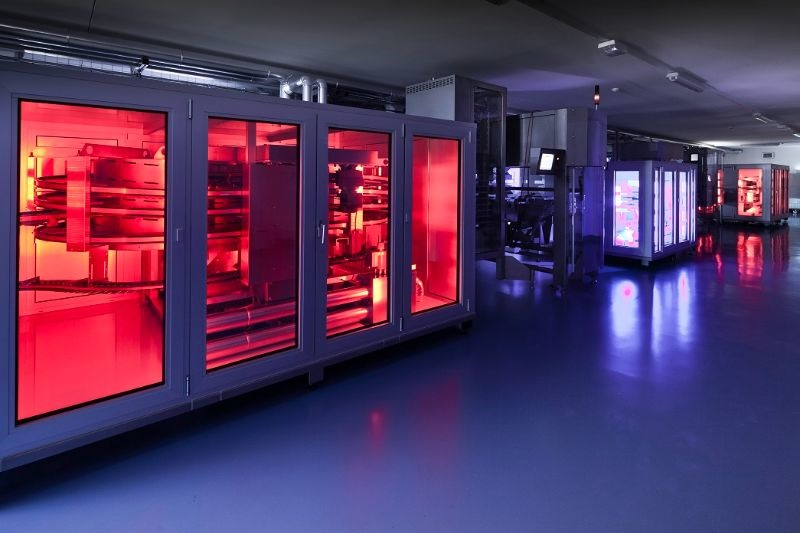 Wide image of industrial chocolate moulding line.