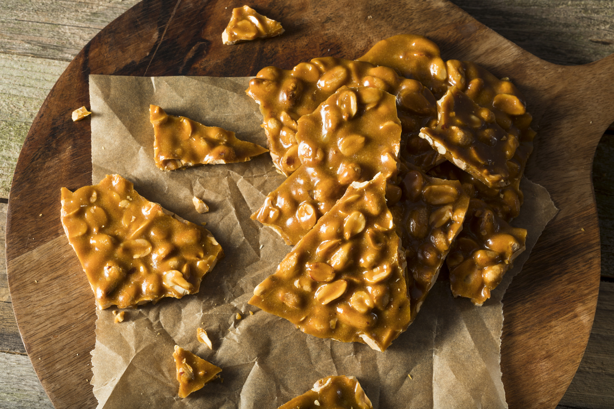 Peanut brittle slabs against baking paper.
