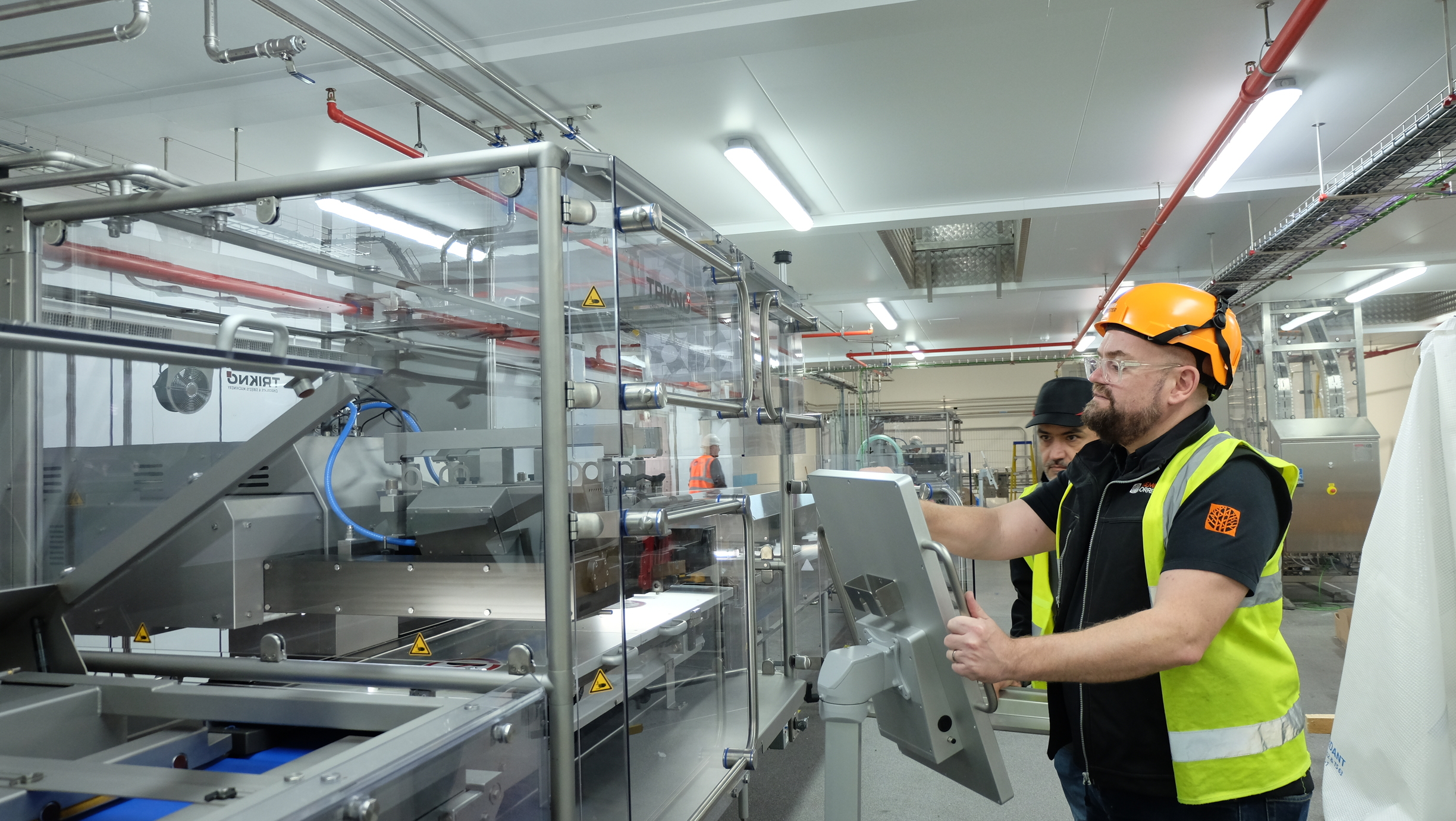 Mike Gee working the Trikno CAD Depositor machine. 