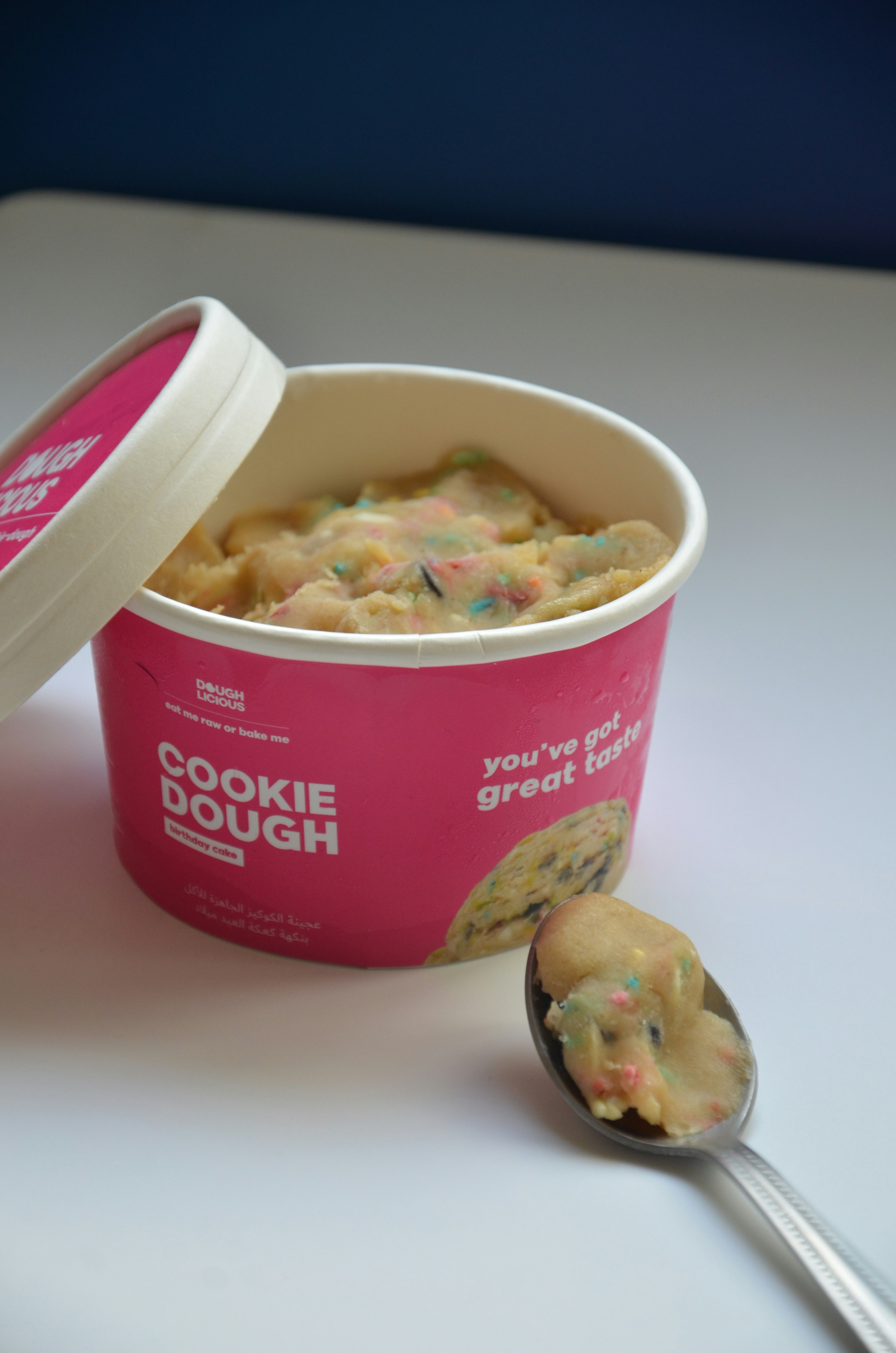 Pink carton of cookie dough with sprinkles.