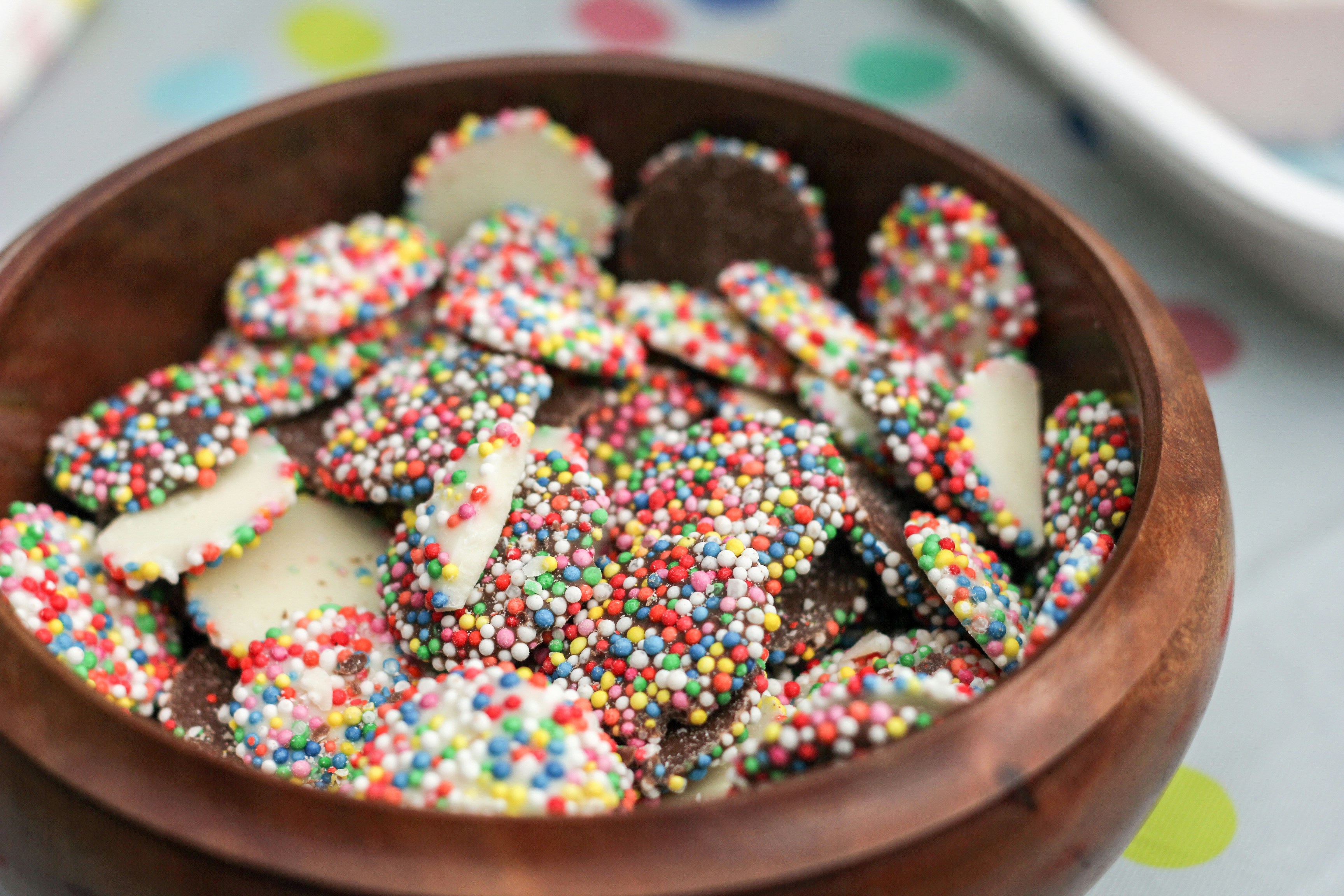 White chocolate buttons with sprinkles on top.